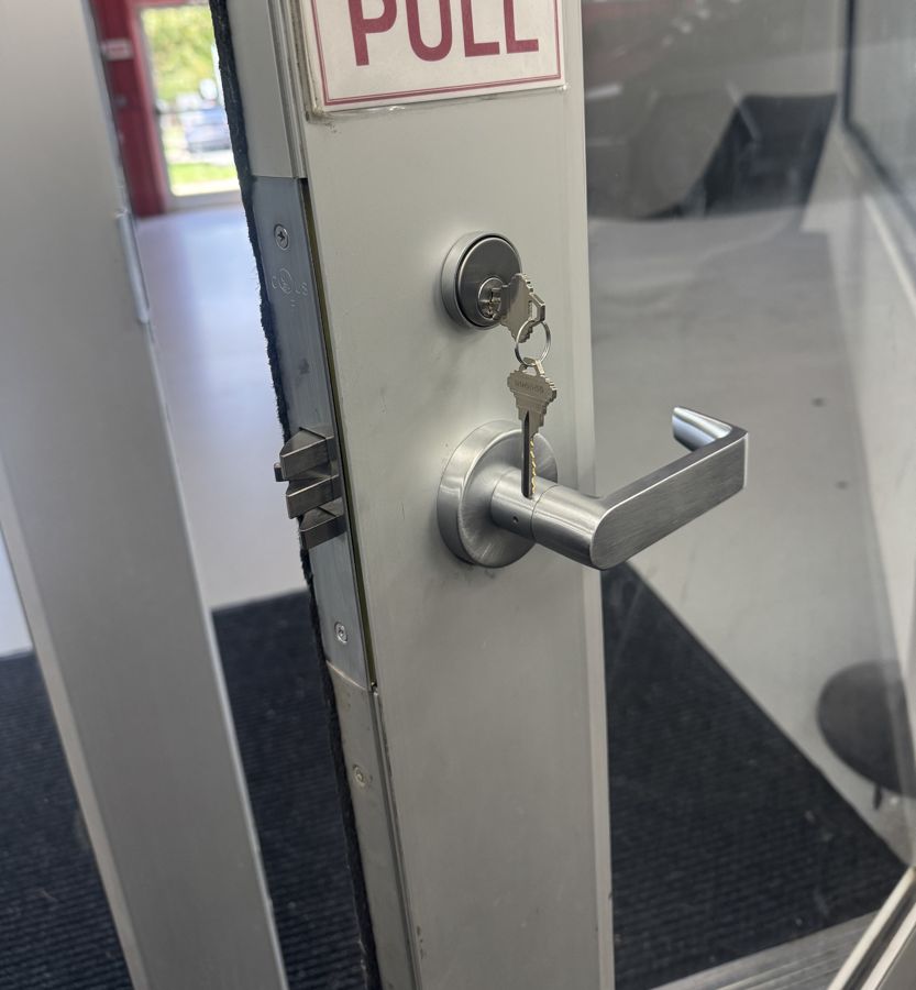 New deadbolt and lever with keys on a glass entry, Matthews NC