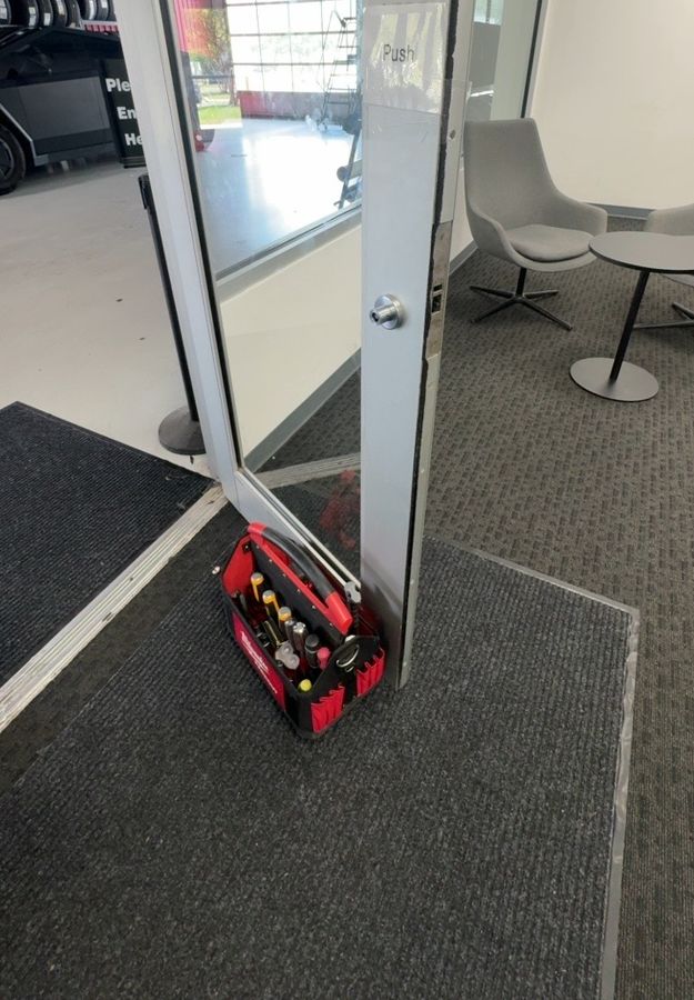 Glass entry door before new hardware, Matthews NC