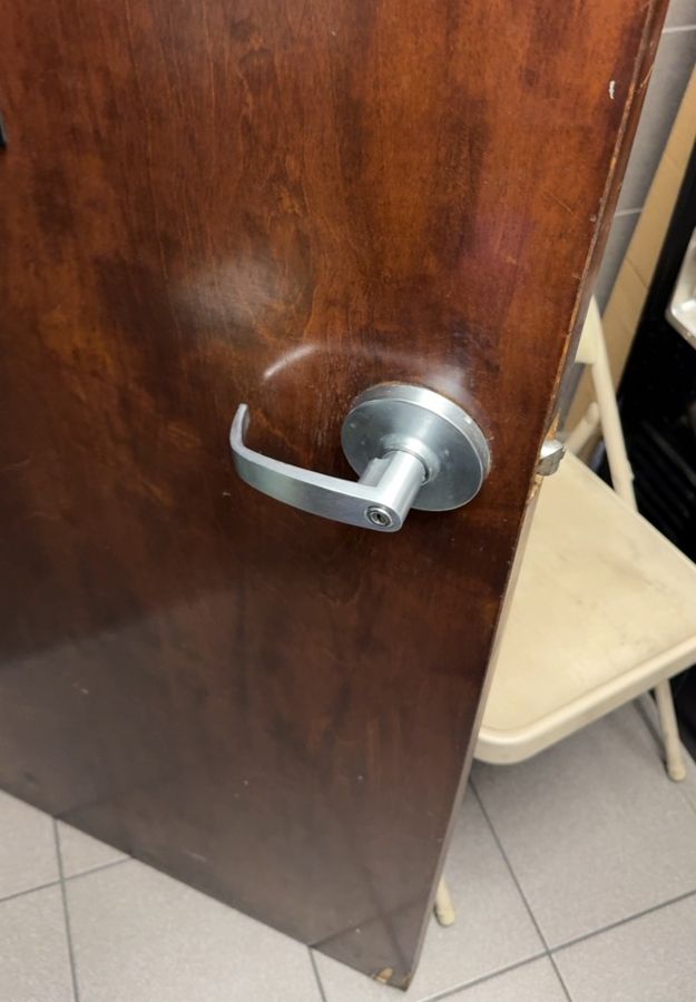 Plain keyed lever on a wood restroom door before the keypad lock went in, Charlotte NC