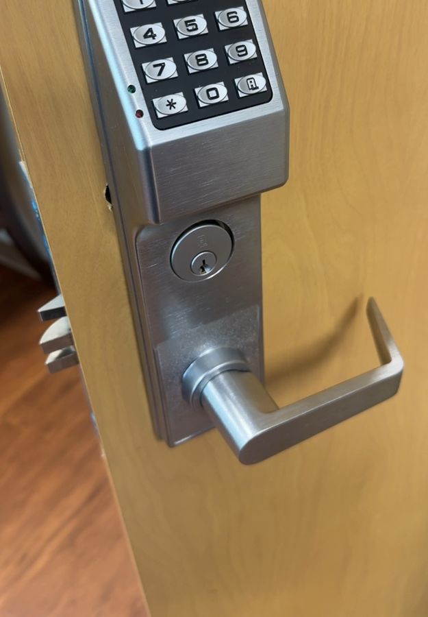 Old keypad lever lock on a wood door before replacement, Kernersville NC