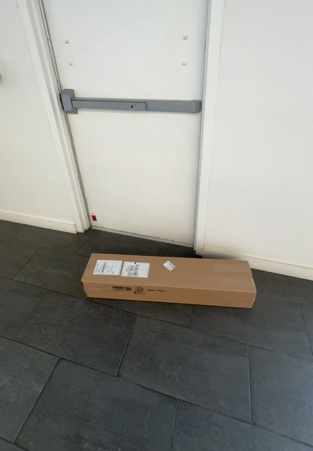 Commercial door with boxed replacement hardware before installation, Charlotte NC