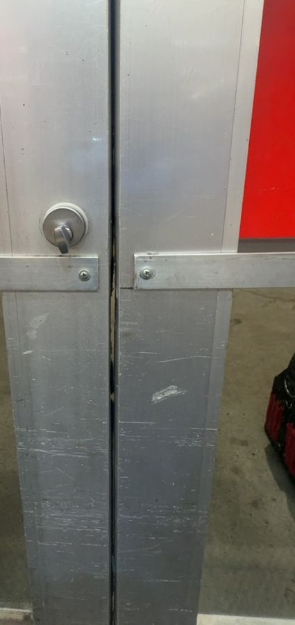 New cylinder with key installed in an aluminum storefront door, Gastonia NC