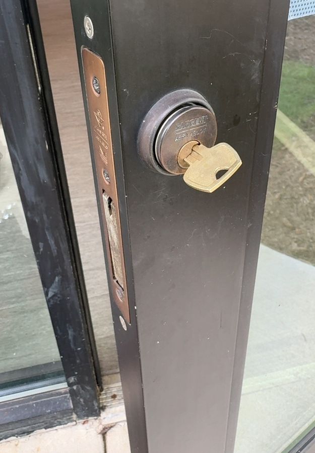 Worn storefront deadbolt before replacement, Charlotte NC